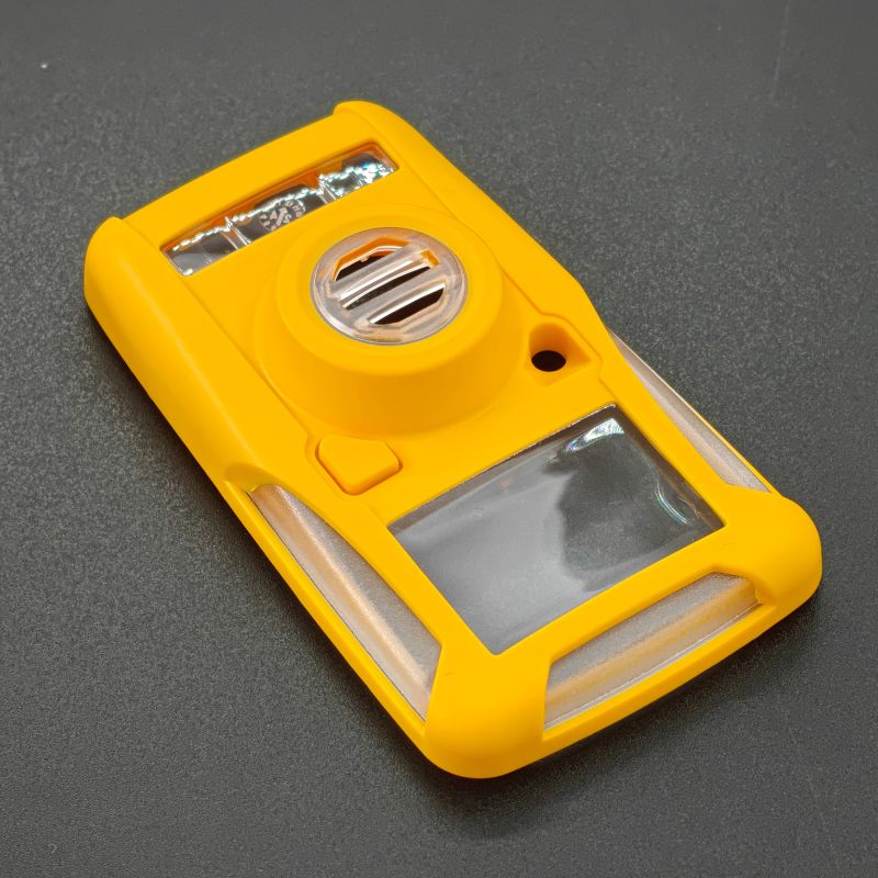 Safety yellow ABS 2K injection molded portable gas detector housing with clear sensor window and circular sensor port, manufactured by ABERY for USA industrial safety customer
